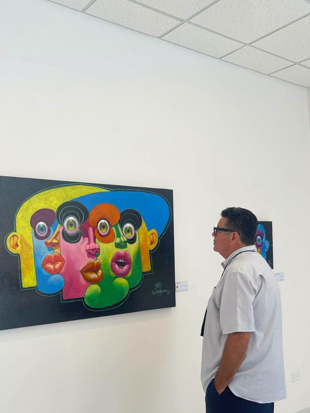 A visitor looking at a Puzzle painting in the gallery