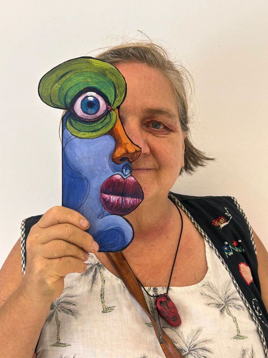 Rocío Hoffmann smiling behind a Puzzle face piece