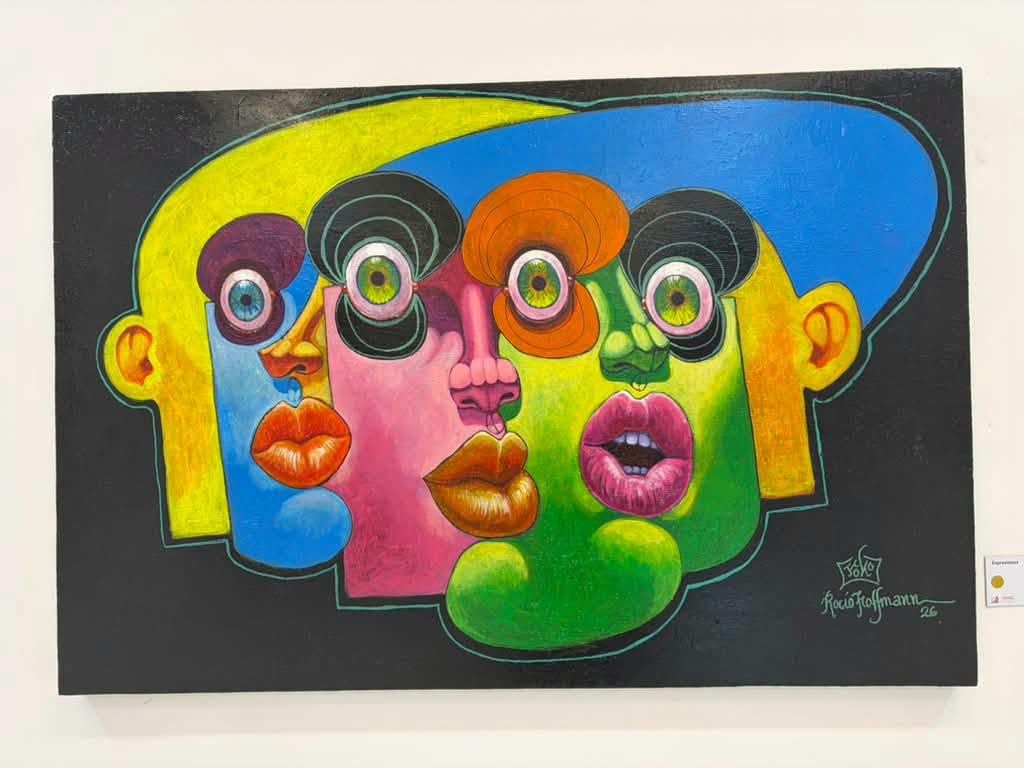 Puzzle painting: three colorful faces fitted together on a black background