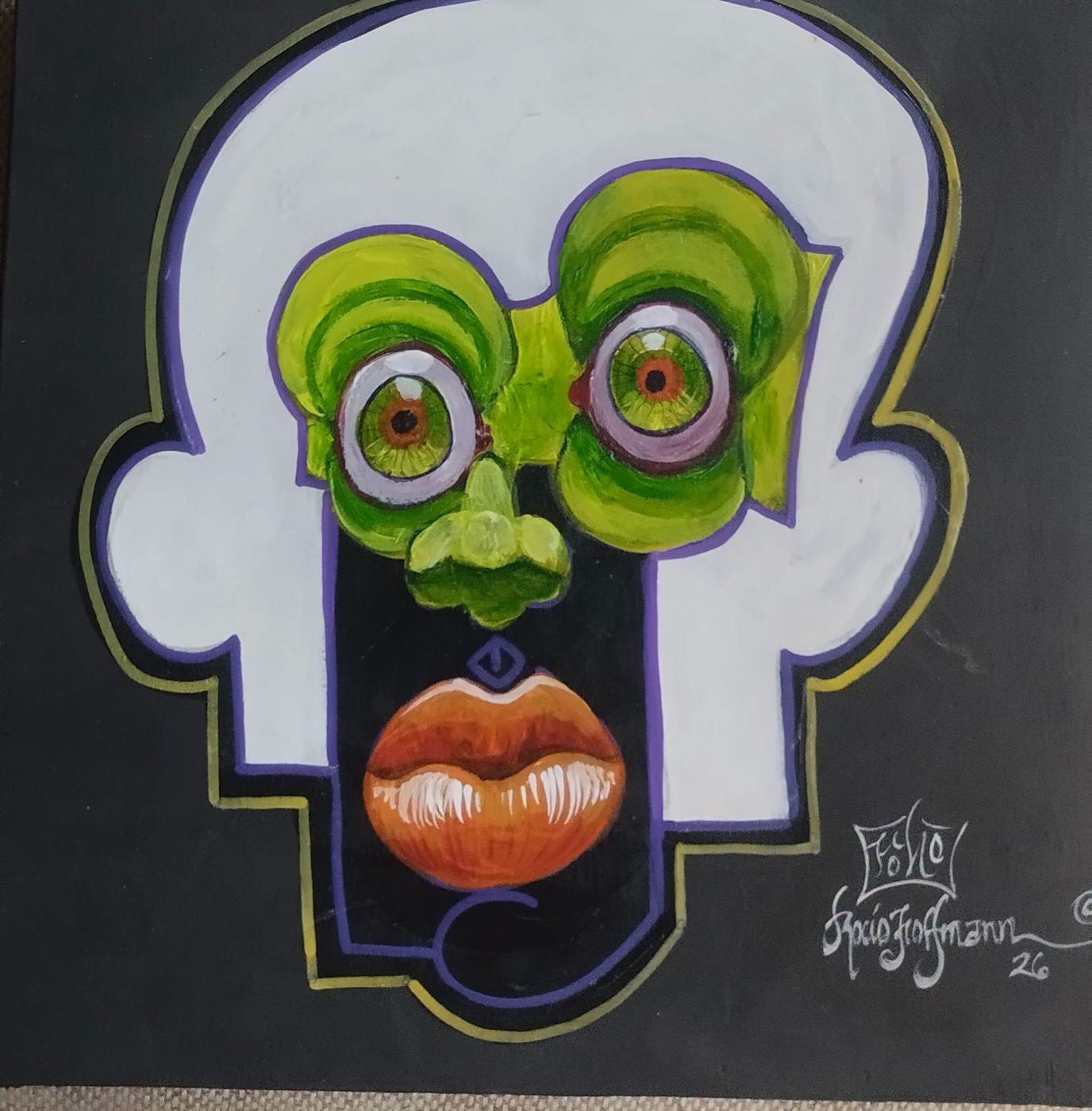 Puzzle painting: a pale face on a black background with green eyes and orange lips