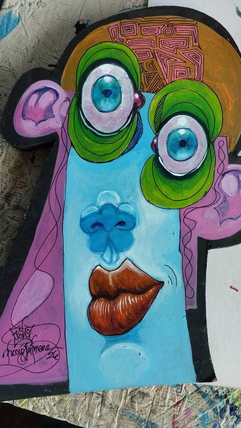 Cut-out Puzzle piece: a light blue face with a patterned orange head, green circles around the eyes and red lips